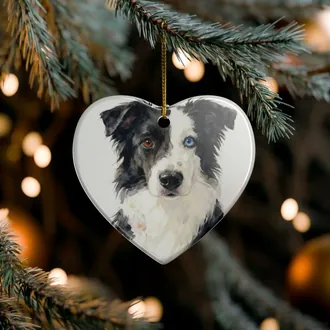 Heart-shaped ceramic ornament with a watercolor dog portrait hanging on a Christmas tree