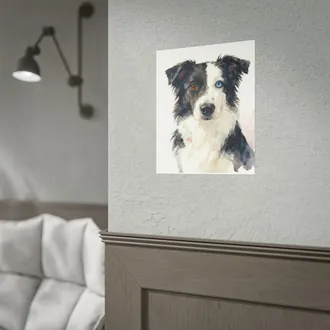 Poster of a watercolor dog portrait on a gray wall above wood paneling, next to a wall lamp